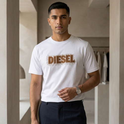Diesel white drop shoulder t-shirt with embroidered fuzzy logo – man wearing in architectural setting