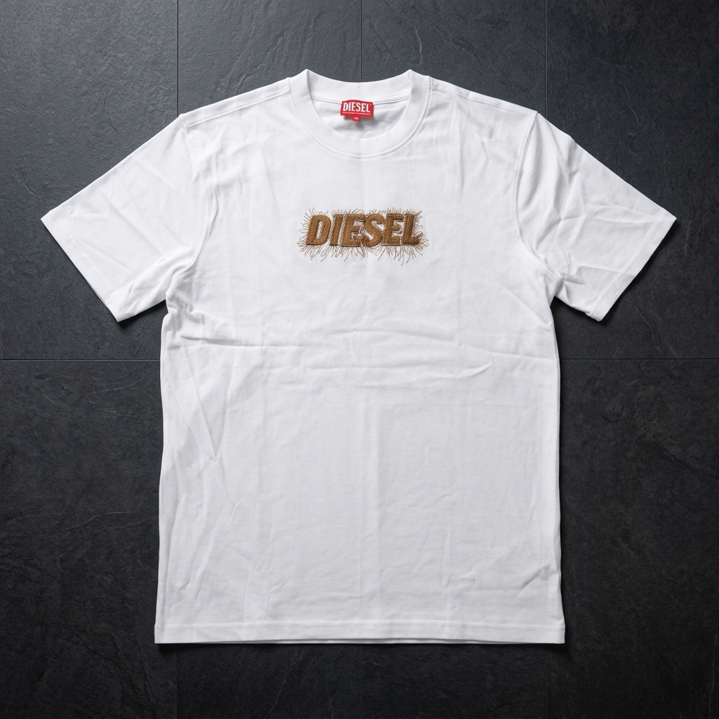 Diesel white drop shoulder t-shirt – flat lay on dark surface showing embroidered logo detail