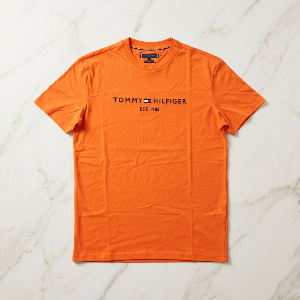 Tommy Hilfiger orange t-shirt – man wearing front view in modern interior setting